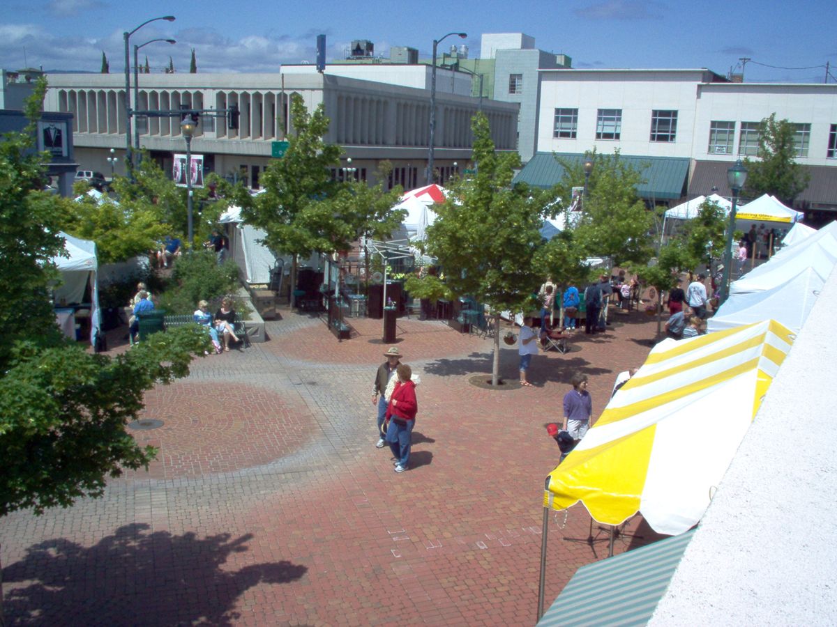 Festival tents and people filling Vogel Plaza in downtown Medford during Art in Bloom
